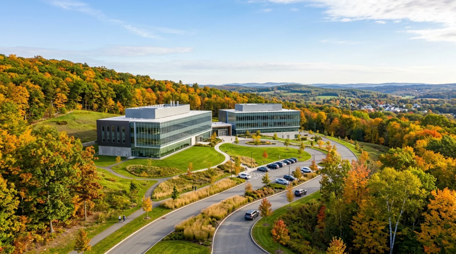 A modern biomanufacturing campus on a green hillside in Central Massachusetts